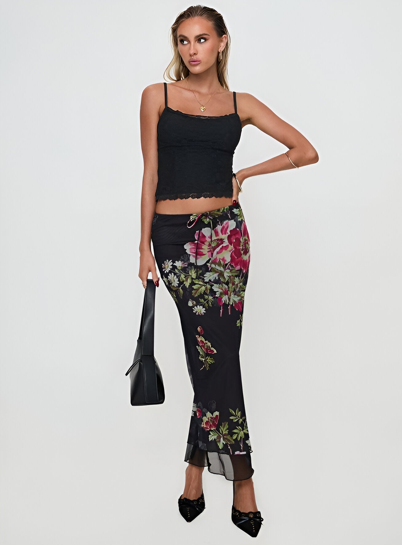 Stylish woman in floral trendy maxi skirts paired with a black top and accessories