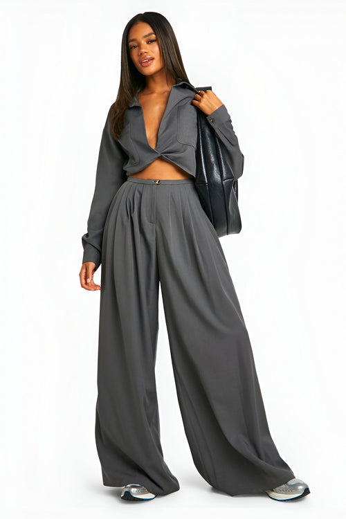 Stylish model wearing women's trendy pants paired with a chic cropped top and sleek bag