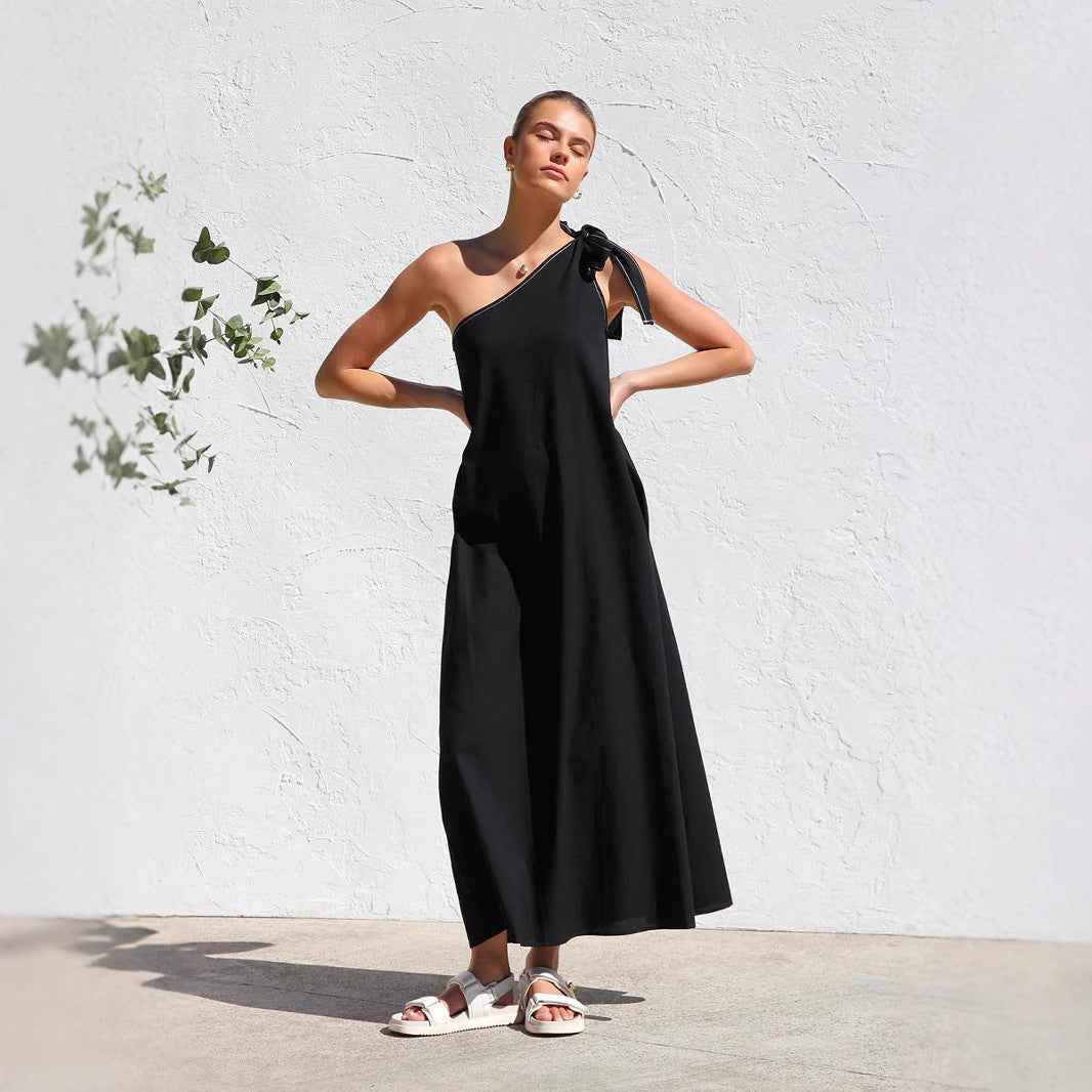 Zemy lace up sloping shoulder dress in black with a stylish bow detail and flowy design